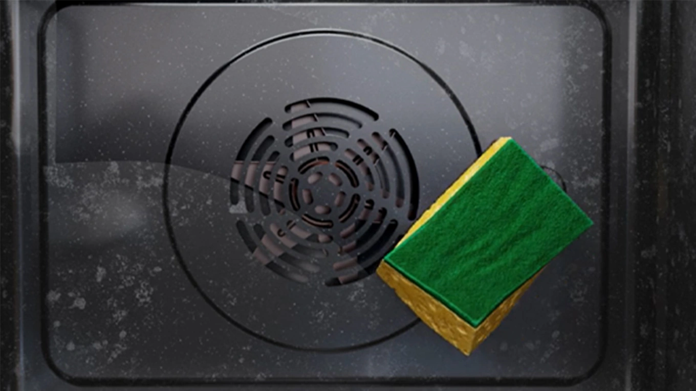 Bauknecht Backofen Selbstreinigung Gelb grüner Schwamm wischt die Backofen Rückwand im Bauknecht Backofen sauber