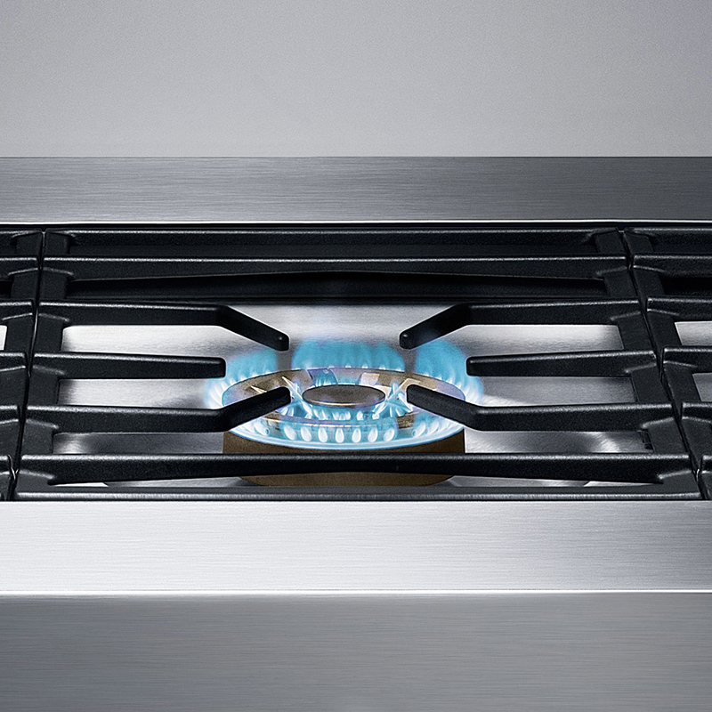 detailaufnahme von einem gaggenau gaskochfeld mit blauem licht am brenner