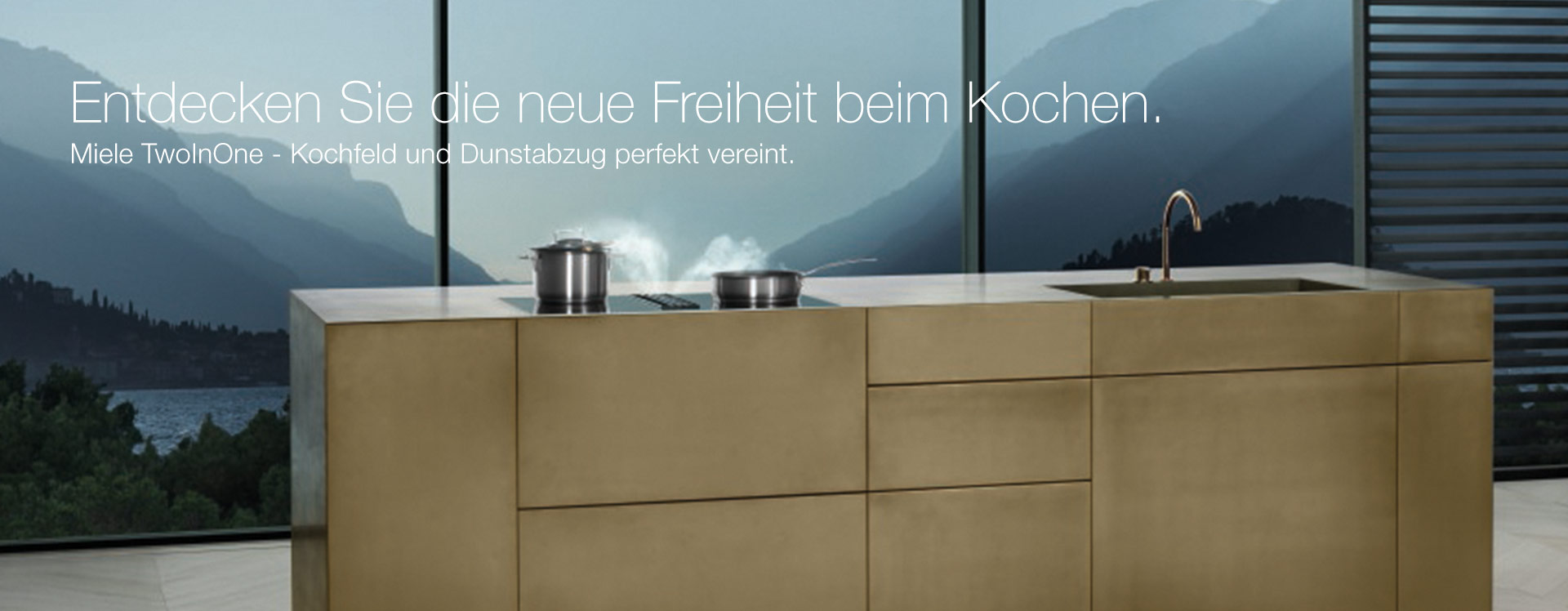 küchenblock vor einer glasfront mit einem miele kmda kochfeld und einer spüle