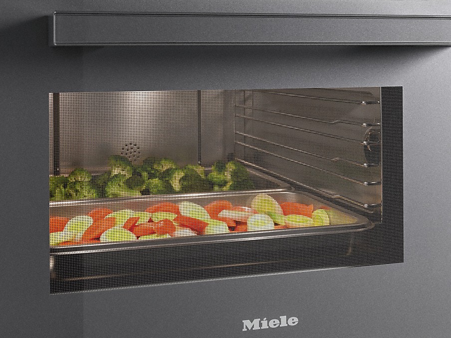 Miele Backofentür Gemuese auf einem Blech hinter einer durchsichtigen Miele Backofentuer