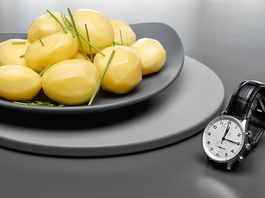 Miele Schnellgaren Kartoffeln mit Schnittlauch auf einem grauen teller neben einer schwarzen Armbanduhr