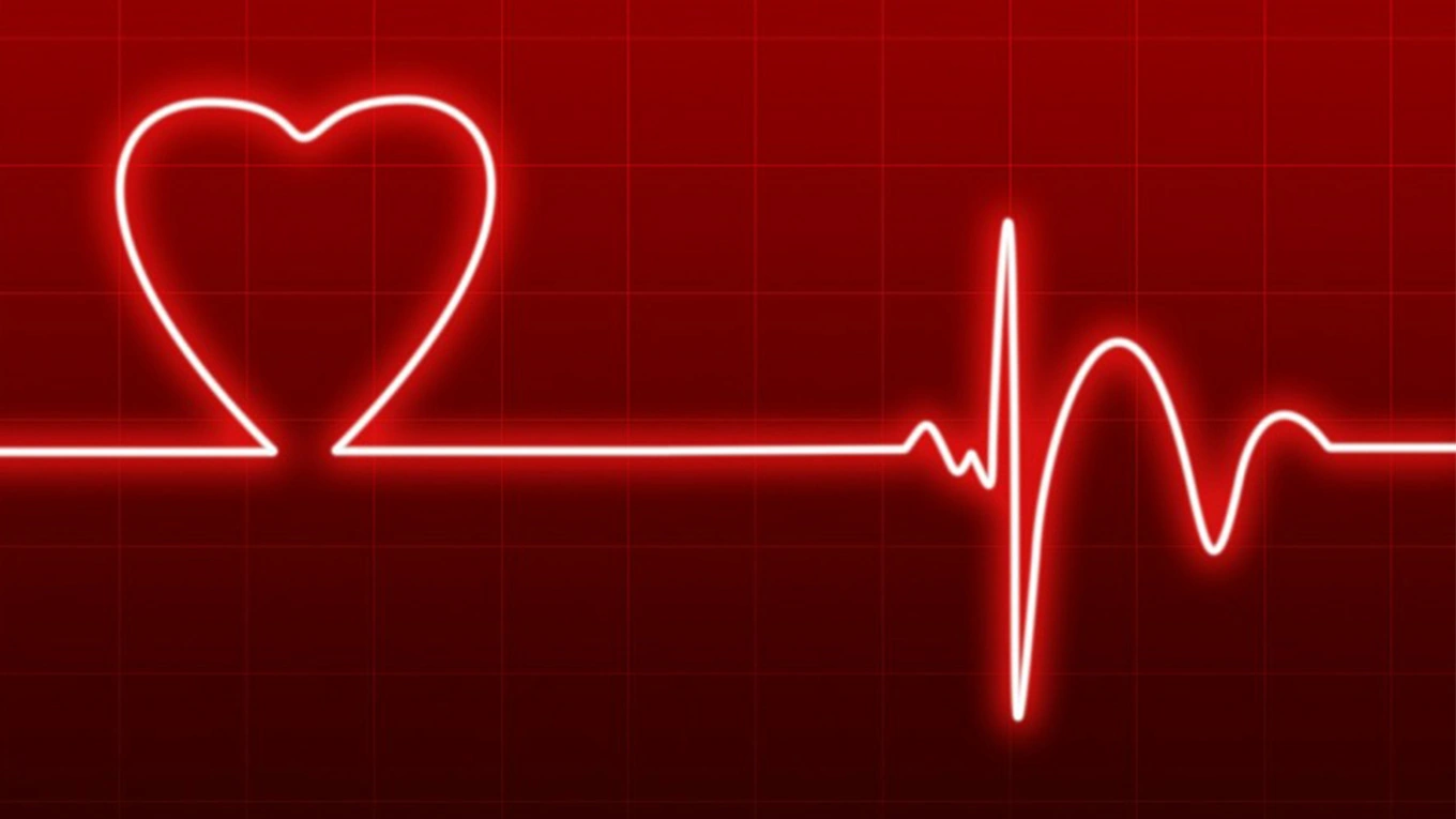 Gesundheit symbolbild herz gesundheit mit rot leuchtender linie mit herz vor rotem hintergrund