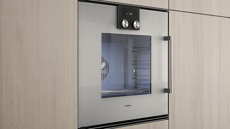 Gaggenau Serie 200 Backofen Ein Gaggenau Serie 200 Backofen in silber von der seite in einer hellen holz kuechenfront